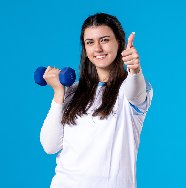 Young female exercising with blue dumbbells